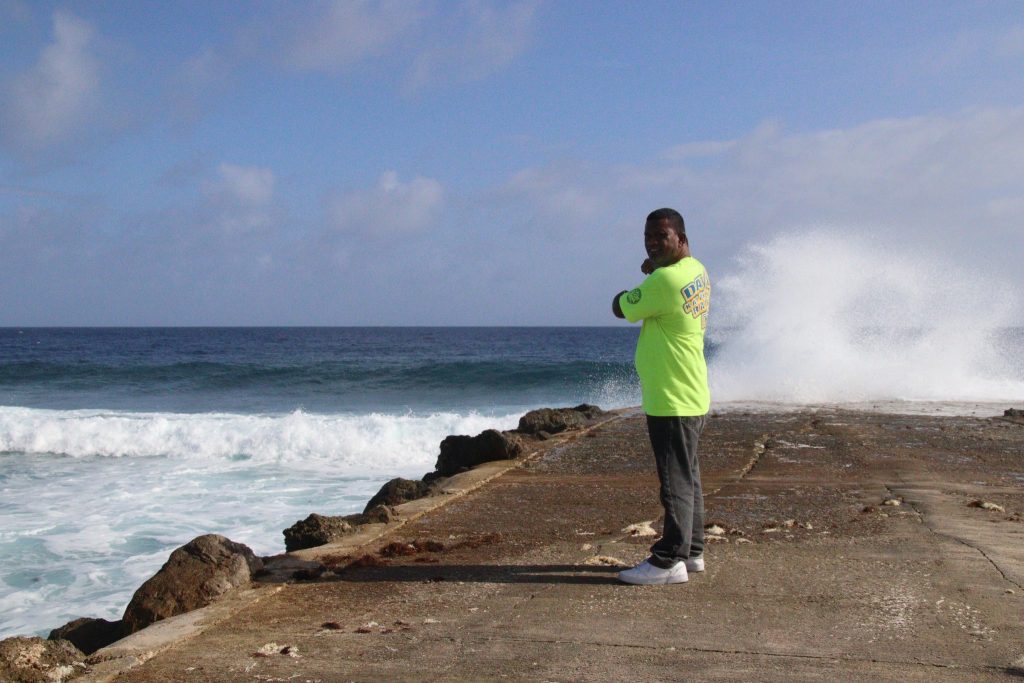 Michael pointing to the area where the waves have started to come onto land