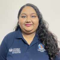 Picture of Sweta Chand with her hair open and laying on her left shoulder. She is wearing the PDF polo shirt and smiling at the camera